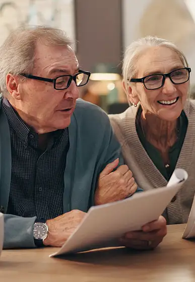 senior couple discussing finances with advisor retirement income strategy our 3 core principles levra financial group illinois