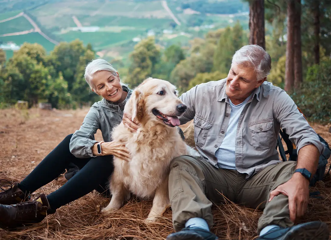 senior couple hiking with dog on mountain life insurance for retirement levra financial group illinois