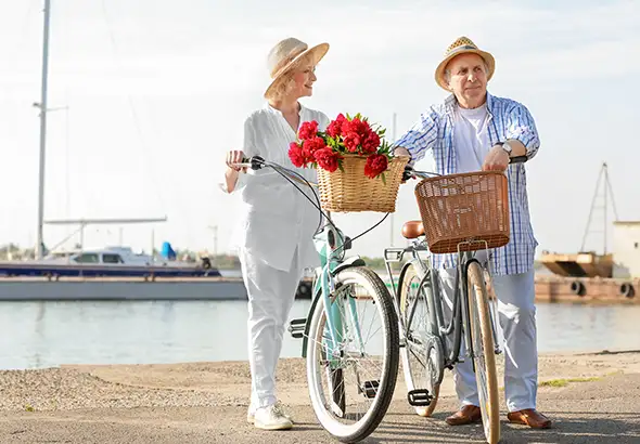 senior couple riding bikes near lake long term care levra financial group illinois